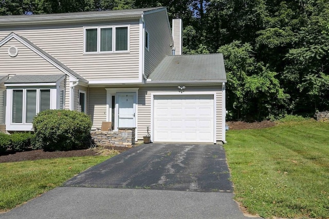 3 Oakwood Ln Unit 3, Worcester, MA 01604 - view of front of property with a garage, driveway, a chimney, and a front lawn