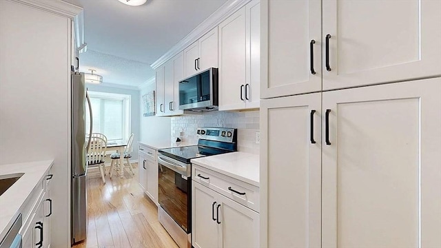 3 Oakwood Ln Unit 3, Worcester, MA 01604 - kitchen with stainless steel appliances, light wood finished floors, white cabinetry, light countertops, and tasteful backsplash