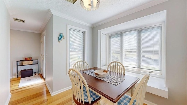 3 Oakwood Ln Unit 3, Worcester, MA 01604 - dining area with light wood-style floors, crown molding, plenty of natural light, and a textured ceiling