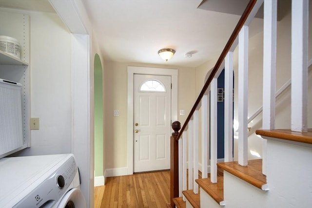 entrance foyer with washer / dryer and light hardwood / wood-style flooring