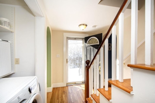 laundry room with hardwood / wood-style flooring and washer / clothes dryer