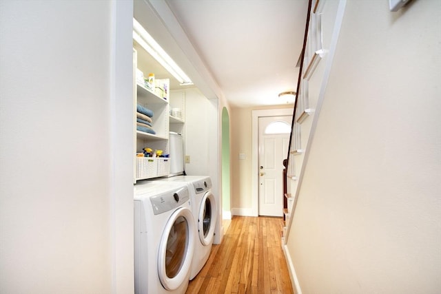 washroom featuring light hardwood / wood-style flooring and washing machine and clothes dryer