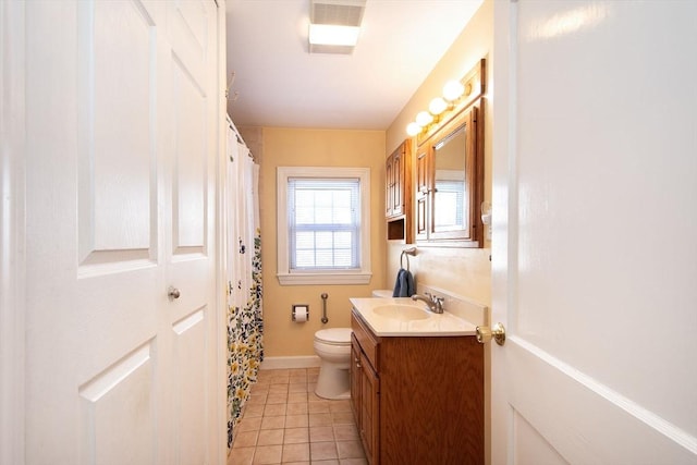 bathroom featuring toilet, tile patterned flooring, and vanity