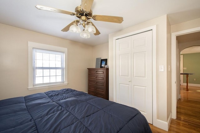 bedroom with ceiling fan, hardwood / wood-style flooring, and a closet