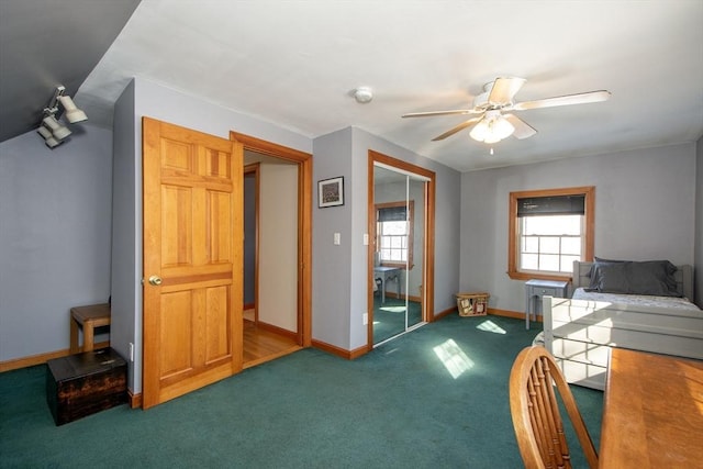 carpeted bedroom with ceiling fan and a closet