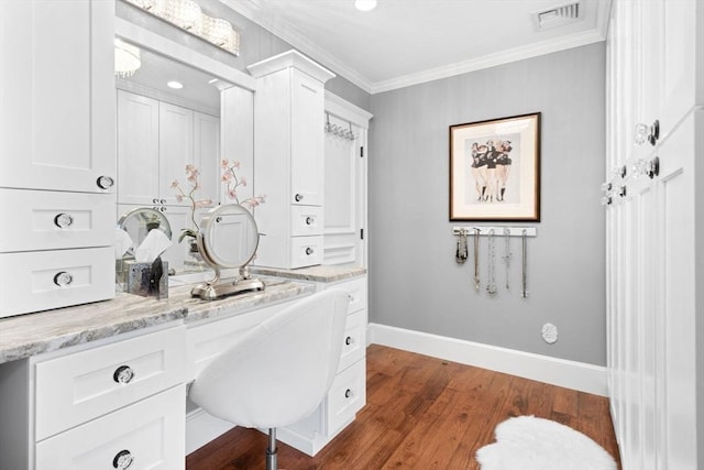 bathroom featuring visible vents, baseboards, crown molding, and wood finished floors