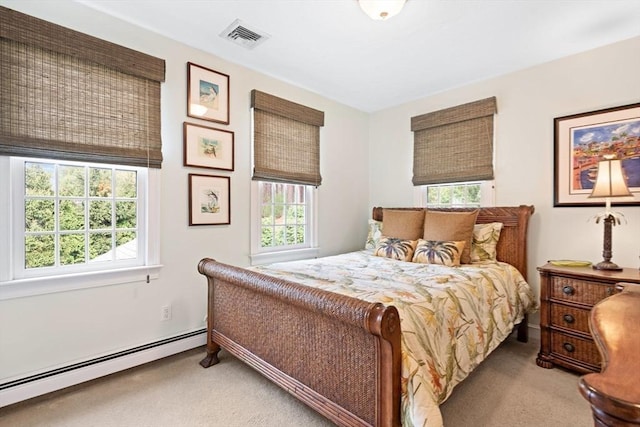 bedroom featuring multiple windows, baseboard heating, carpet flooring, and visible vents