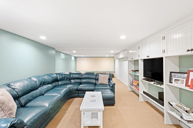 living area with recessed lighting and light colored carpet