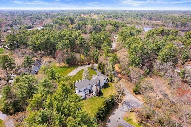 drone / aerial view featuring a forest view and a water view