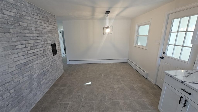 unfurnished dining area featuring brick wall and an accent wall