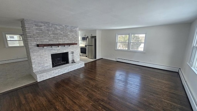 unfurnished living room featuring a baseboard radiator, a brick fireplace, and dark wood-type flooring