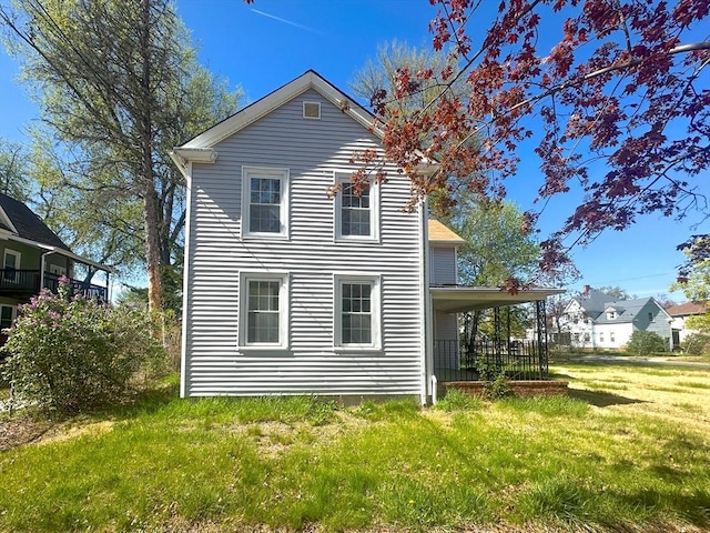 back of house with a lawn