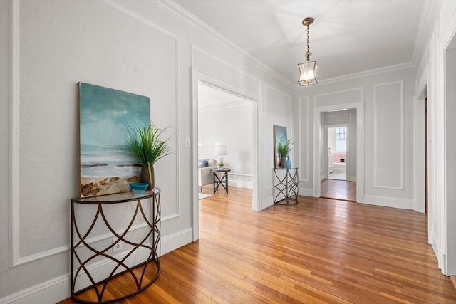 foyer entrance featuring hardwood / wood-style flooring and ornamental molding