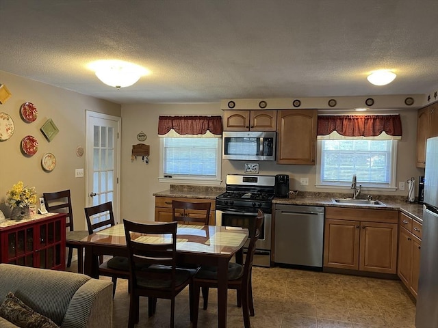 48 Birchcroft, Leominster, MA 01453 - kitchen featuring stainless steel appliances, dark countertops, healthy amount of natural light, and a textured ceiling