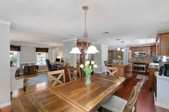 dining area with ornamental molding, a baseboard heating unit, dark wood finished floors, and visible vents