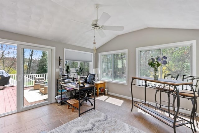 office featuring baseboards, stone tile floors, ceiling fan, and vaulted ceiling