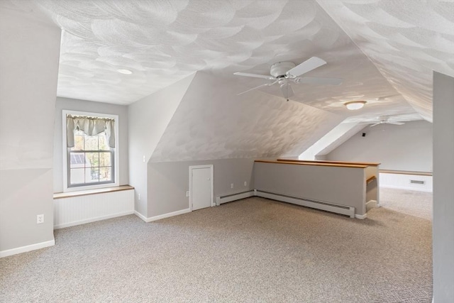 additional living space with a ceiling fan, carpet flooring, and lofted ceiling