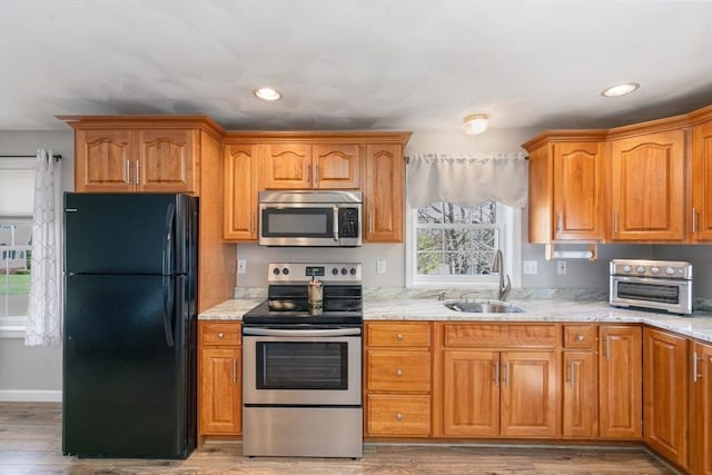 kitchen featuring a sink, appliances with stainless steel finishes, recessed lighting, and a toaster