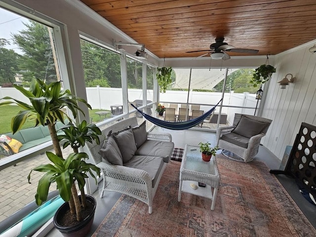 sunroom featuring wood ceiling and ceiling fan