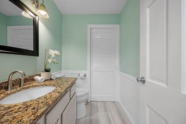 bathroom featuring vanity and toilet