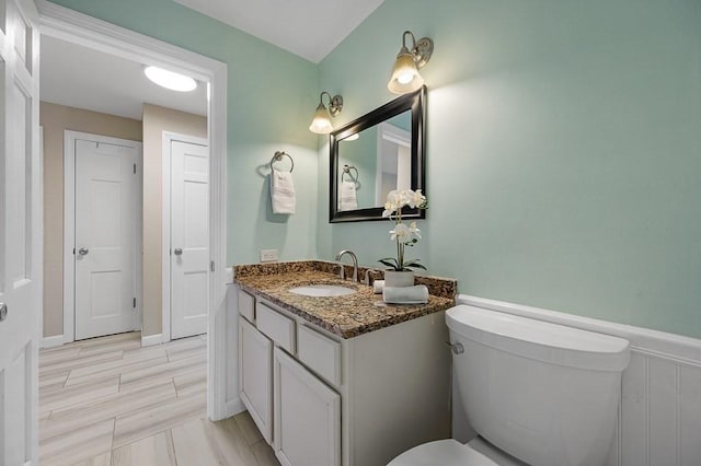 bathroom featuring vanity and toilet