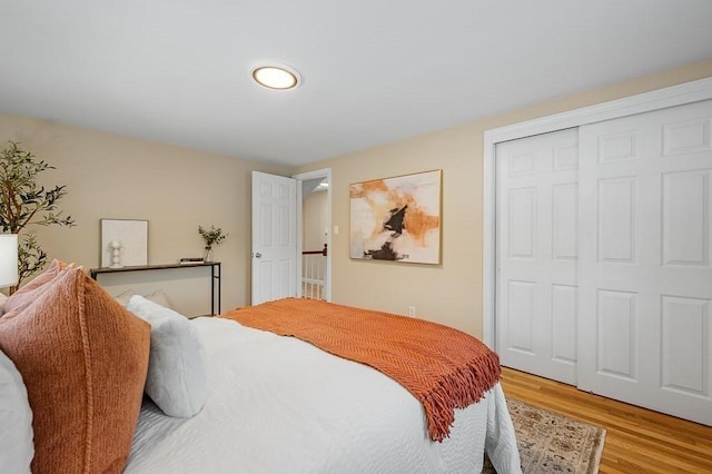 bedroom featuring light wood-type flooring and a closet