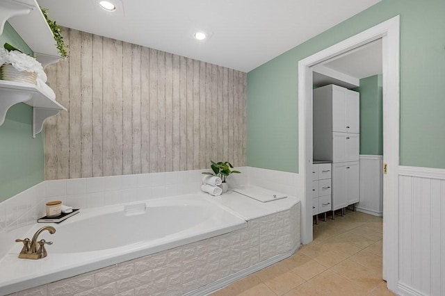 bathroom featuring a washtub and tile patterned floors