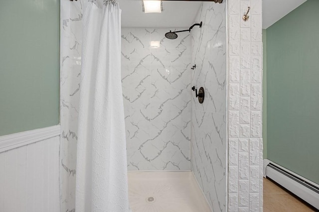 bathroom with baseboard heating, tile patterned floors, and a shower with shower curtain