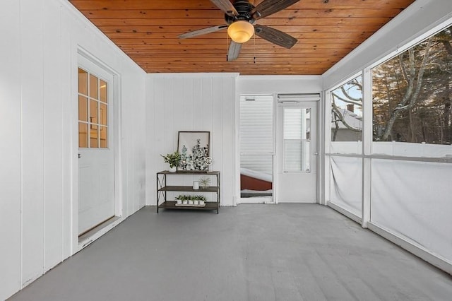 unfurnished sunroom with wood ceiling and ceiling fan