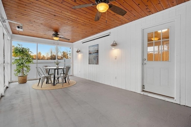 unfurnished sunroom with wooden ceiling and ceiling fan