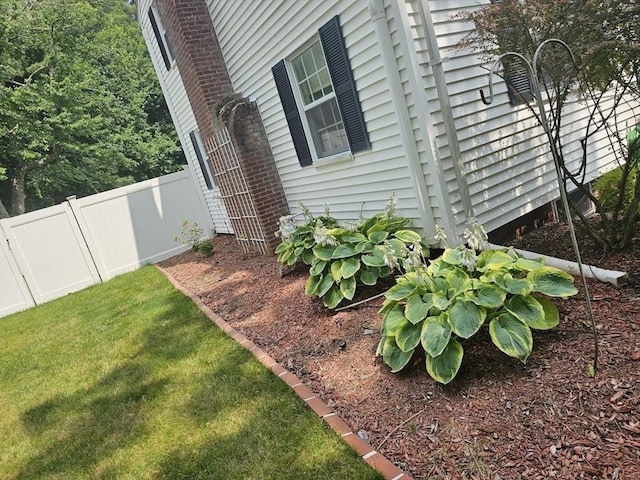 view of side of home featuring a lawn