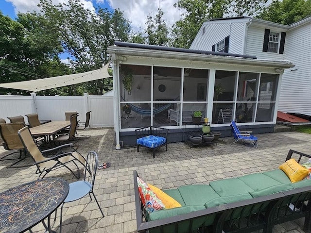 back of house with a patio, outdoor lounge area, and a sunroom