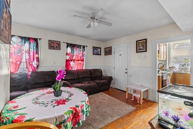 living room with ceiling fan and light hardwood / wood-style flooring