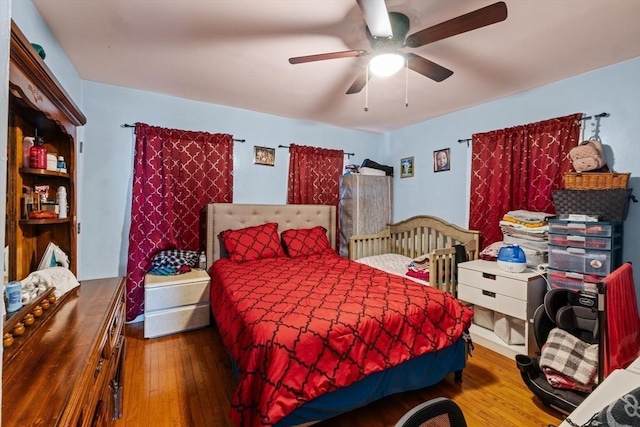 bedroom with hardwood / wood-style flooring and ceiling fan