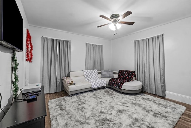 living room featuring dark hardwood / wood-style floors and ceiling fan