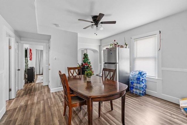 dining room with ceiling fan and hardwood / wood-style floors