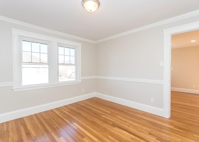 unfurnished room with hardwood / wood-style flooring and ornamental molding