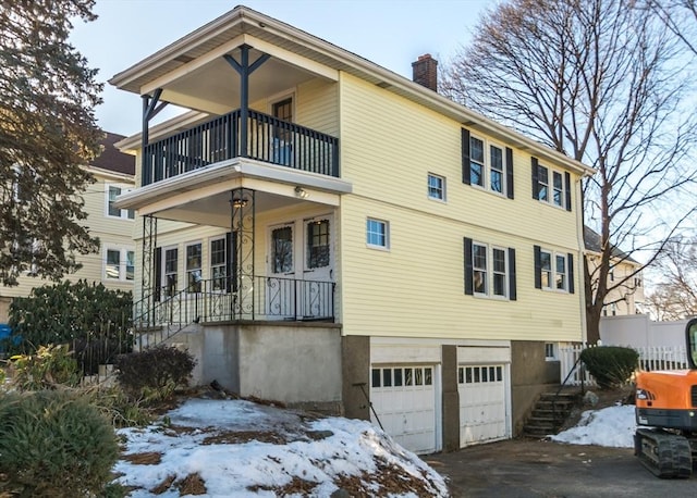 view of front of home featuring a garage and a balcony