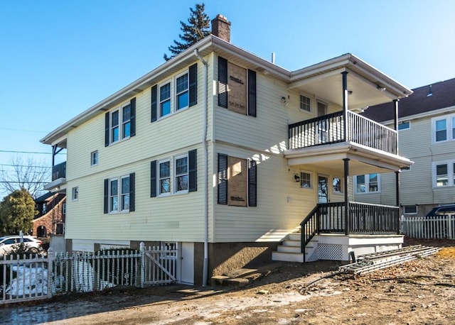 back of house with a balcony