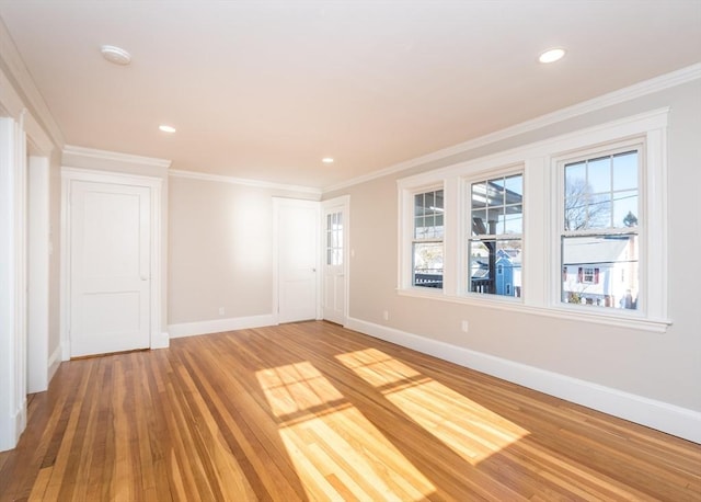 empty room featuring crown molding and hardwood / wood-style floors