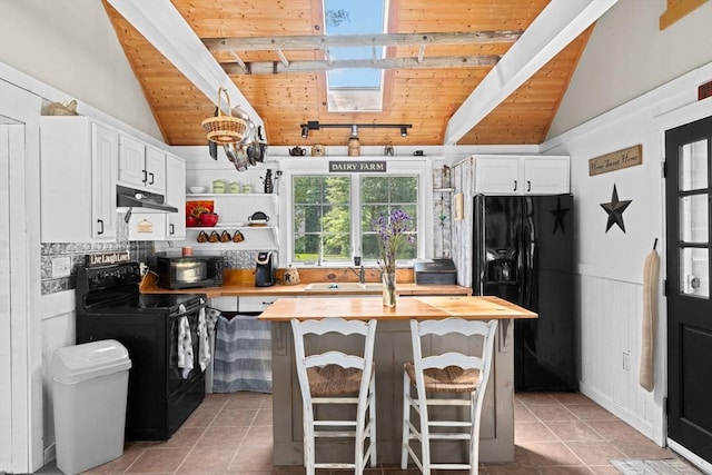 18 Russell Holmes Way, Carver, MA 02330 - kitchen featuring black appliances, butcher block counters, light tile patterned floors, wood ceiling, and under cabinet range hood
