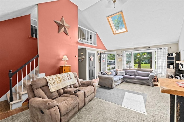 18 Russell Holmes Way, Carver, MA 02330 - carpeted living area featuring a skylight, high vaulted ceiling, and stairway