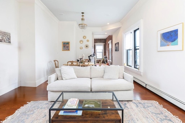 living area featuring crown molding, baseboards, wood finished floors, and a baseboard radiator