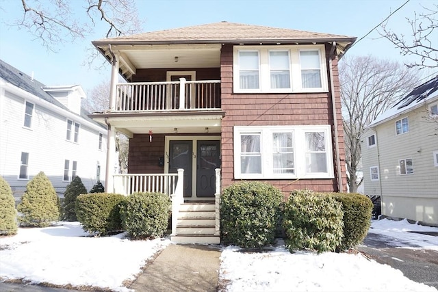 view of front of property with a balcony and covered porch