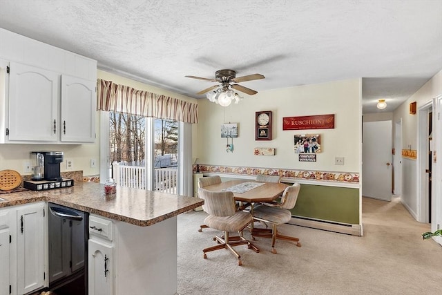 kitchen with a baseboard radiator, white cabinets, light colored carpet, kitchen peninsula, and a textured ceiling