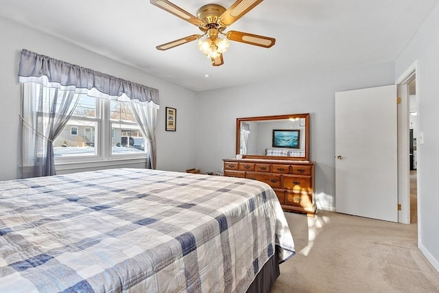 bedroom featuring light colored carpet and ceiling fan