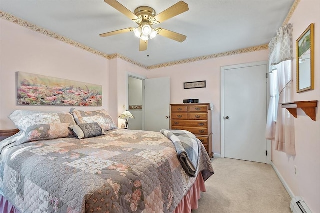 bedroom with ceiling fan, light carpet, and a baseboard heating unit