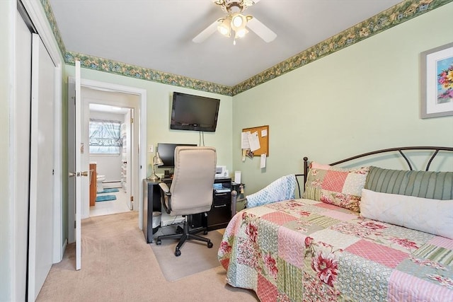 carpeted bedroom featuring ceiling fan and a closet