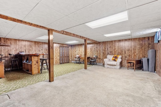 basement featuring carpet floors, bar area, and baseboard heating