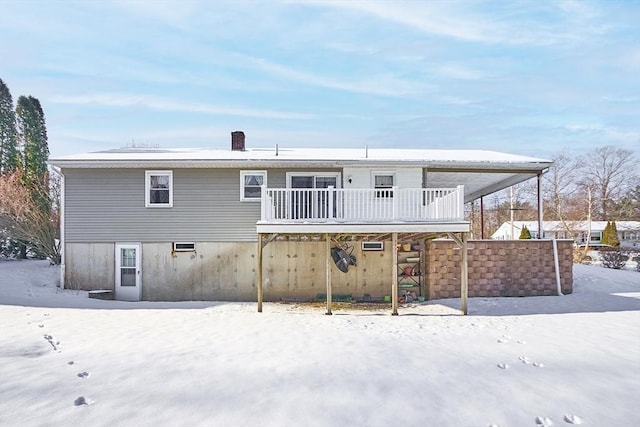 snow covered property featuring a wooden deck